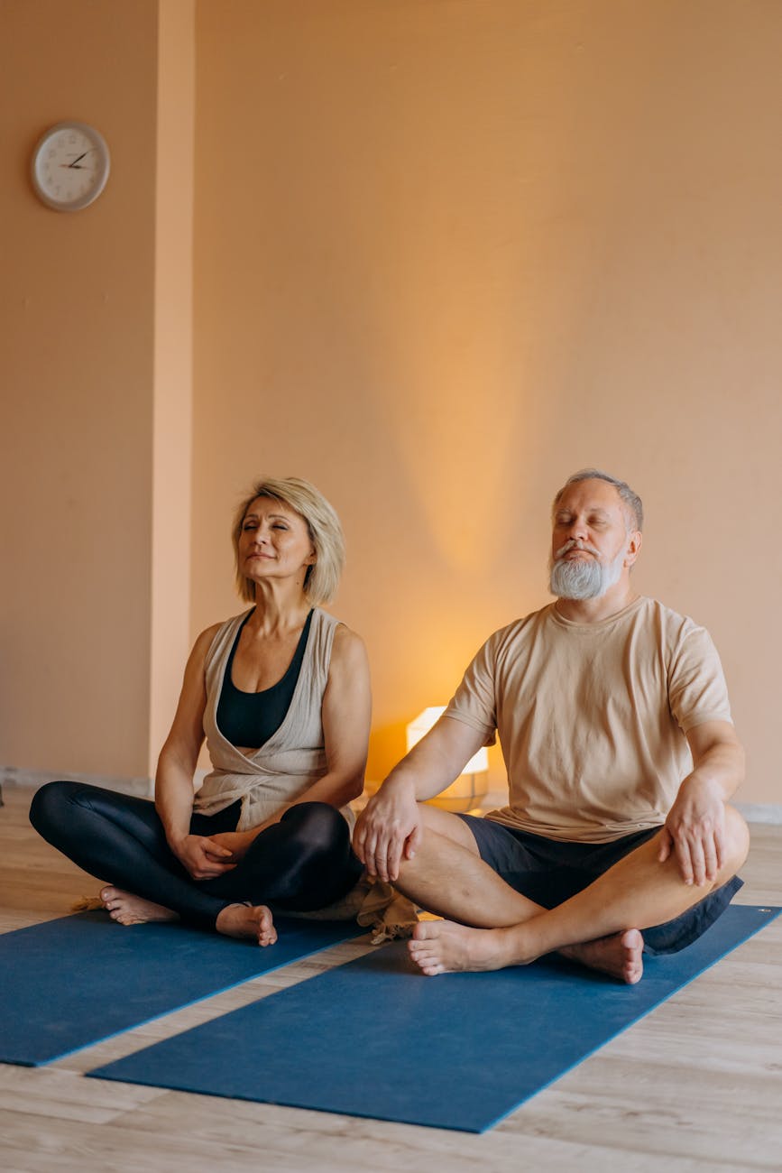 elderly couple meditating
